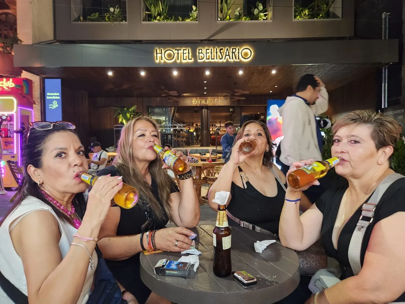 Travelers toasting with a cold drink downtown